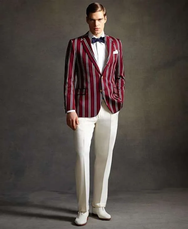 Белые брюки со стрелками, белая рубашка, бордовый пиджак с полосками, галстук-бабочка.